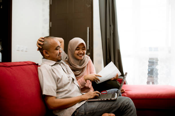 istock young asian couple using laptop to pay bill at home 1286645118