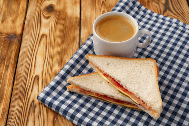 Triangle toasted sandwich on wooden board close up photo