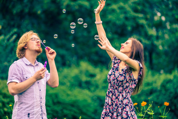 istock Couple blowing bubbles outdoor 1286647051