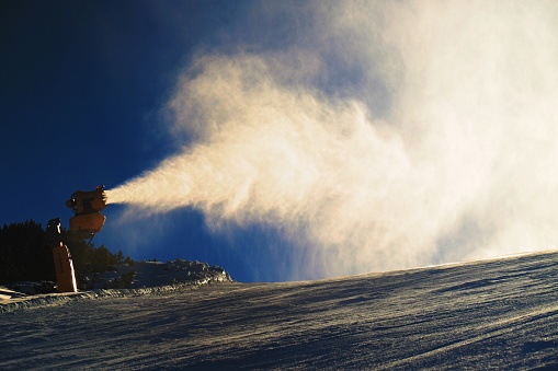 Snow Cannon Making Fresch Powder Snow. Mountain Ski Resort And Winter Calm Mountain Landscape.