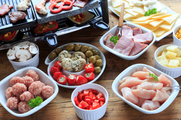 istock Raclette with vegetables, meat and cheese 1286647385