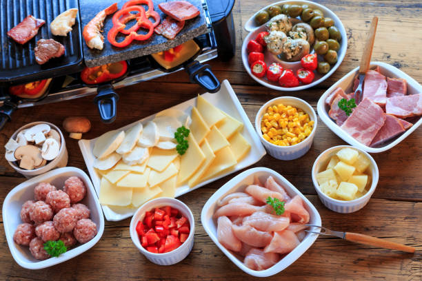 Raclette with vegetables, meat and cheese