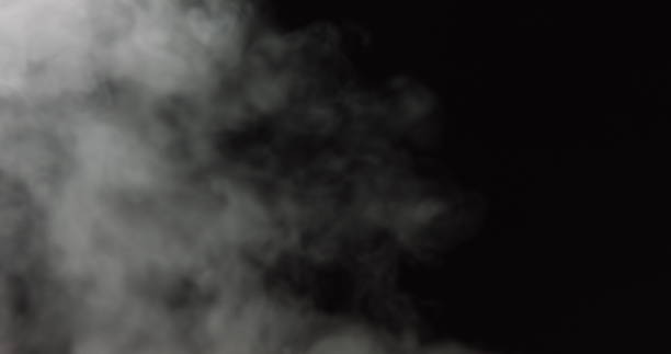 istock Atmospheric smoke VFX overlay element. Haze background. Smoke in slow motion on black background. White smoke slowly floating through space against black background. Mist effect. Fog effect 1286650821