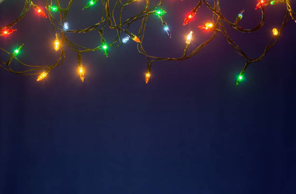 Christmas lights on blue background with copy space stock photo