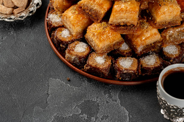 istock Assortment of turkish baklava on black textured surface 1286653159