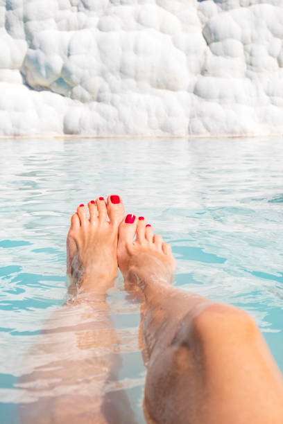 Lovely female feet at spa, Pamukkale, Turkey stock photo