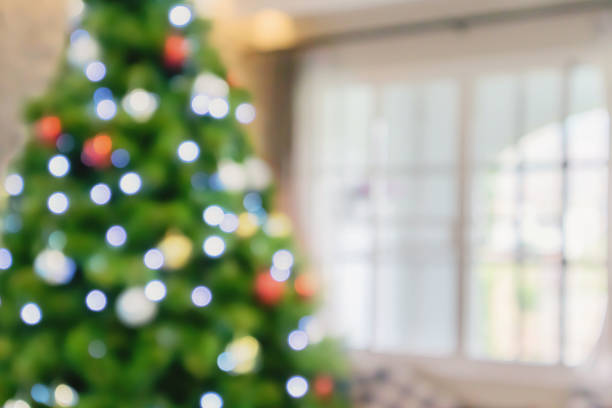 istock Abstract blurred christmas tree with bokeh light in living room background 1286656824