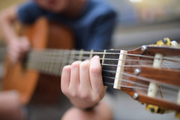 istock A young boy playing guitar outdoors 1286656919