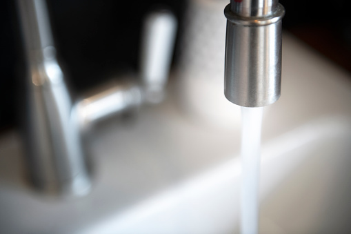 Close-up of water stream from kitchen tap