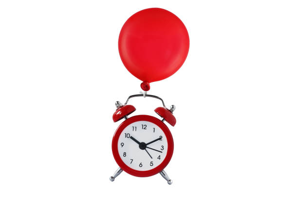 istock Alarm clock flying with a balloon - Time flies concept 1286659106