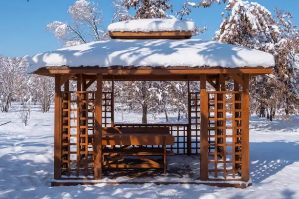 Japanese gazebo in winter park. Beautiful winter landscape. Nature background. Urban scene.