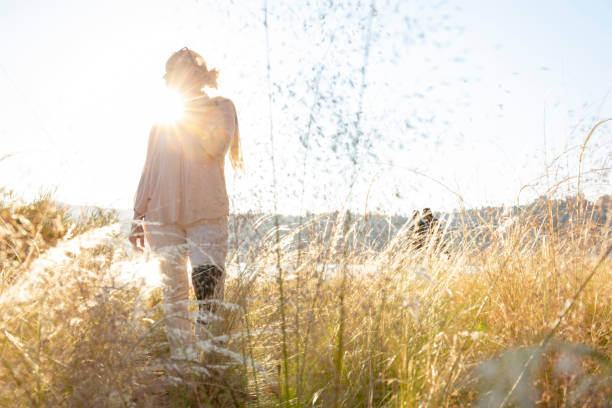 istock Woman walks through gassy meadow at sunrise 1286659309