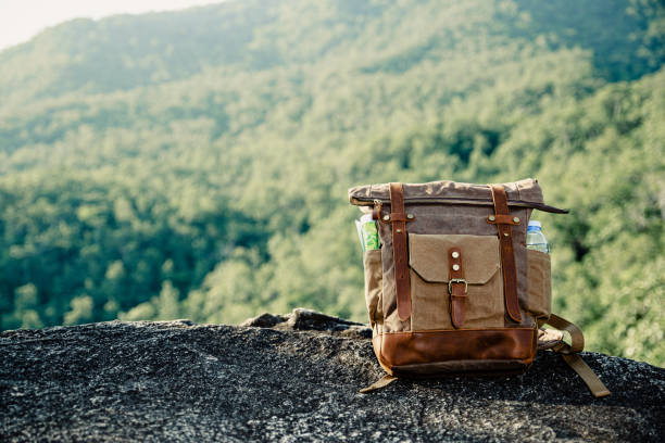 istock Vintage bagpack put on peak of mountain. 1286659485