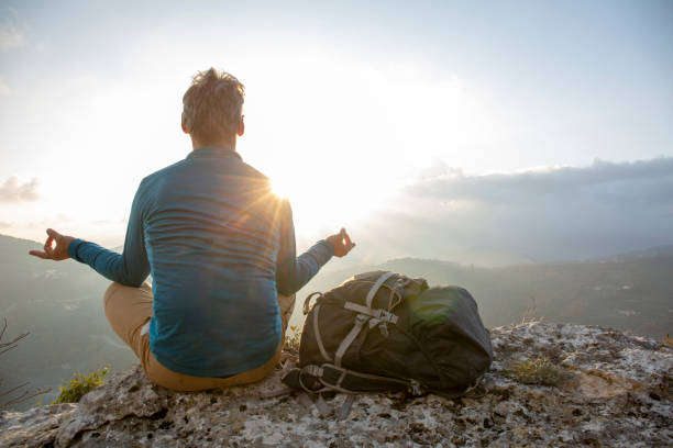 istock Hiker relaxes on mountain ridge at sunrise 1286659500