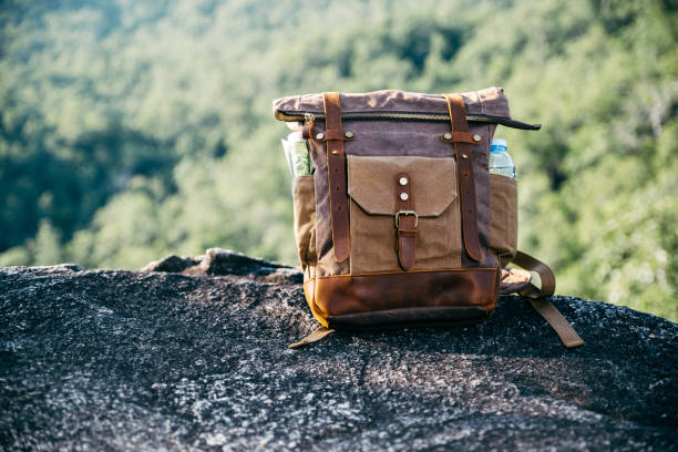 istock Vintage bagpack put on peak of mountain. 1286659512