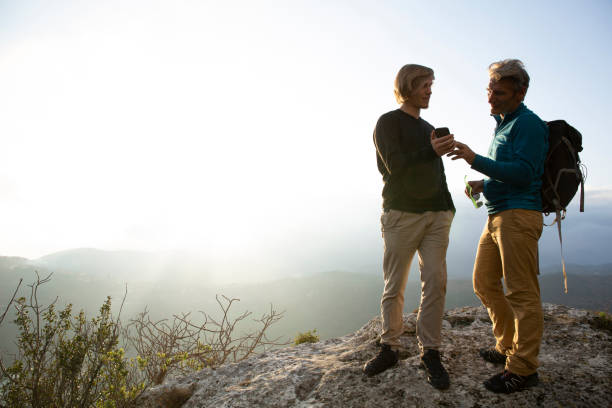istock Hikers relax on mountain ridge at sunrise 1286659572