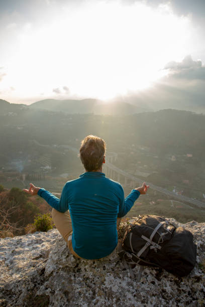 istock Hiker relaxes on mountain ridge at sunrise 1286659573