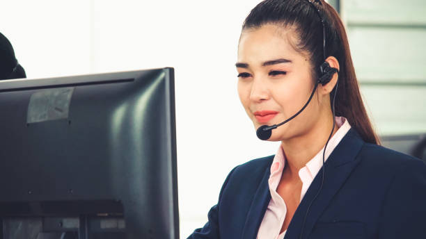 istock Business people wearing headset working in office 1286659661