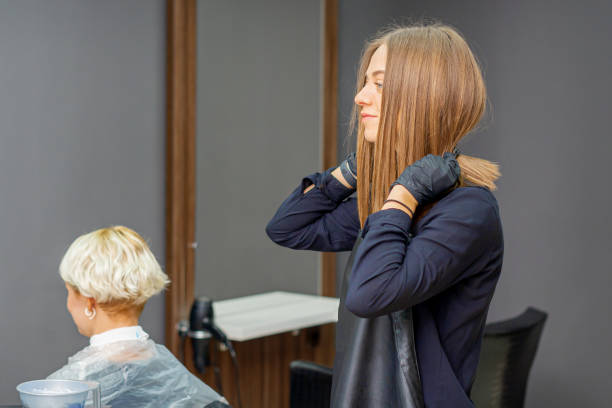istock Hairdresser puts on black apron 1286660248