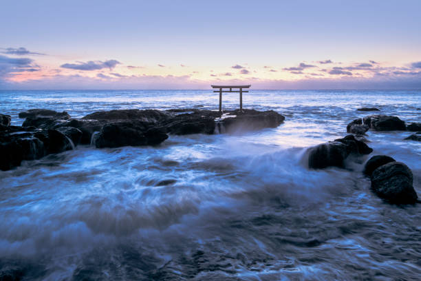 Mysterious torii gate called "Kamiiso no Torii" and Oarai coast before sunrise The torii that stands on Kamiiso, the land where the gods landed, is one of the torii gates of Oarai Isosaki Shrine on the hill along the coast. The torii gate in the sea is very rare. ibaraki prefecture stock pictures, royalty-free photos & images