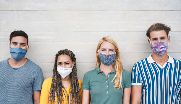 istock Young multiracial people wearing protective masks during coronavirus outbreak - Social distance between friends concept - Main focus on girl with blond hair 1286660343