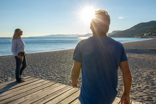istock Mature couple relax by seaside at sunrise 1286660452
