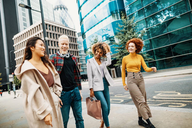 istock Diverse millennials walking down the empty street. Group of multi-ethnic friends 1286660539