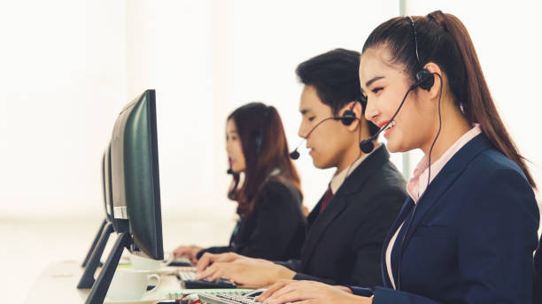 istock Business people wearing headset working in office 1286660739