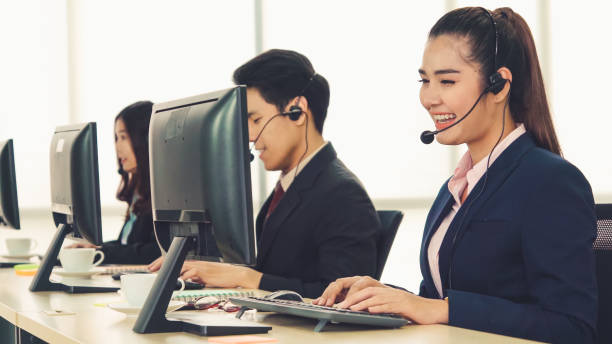 istock Business people wearing headset working in office 1286660988
