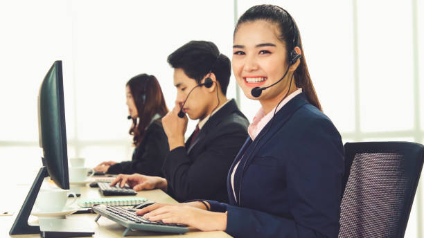 istock Business people wearing headset working in office 1286661623