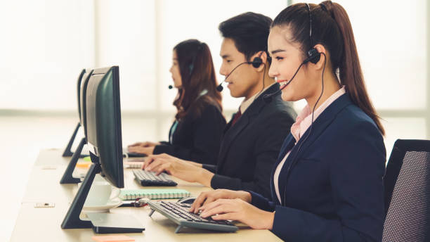 istock Business people wearing headset working in office 1286661838