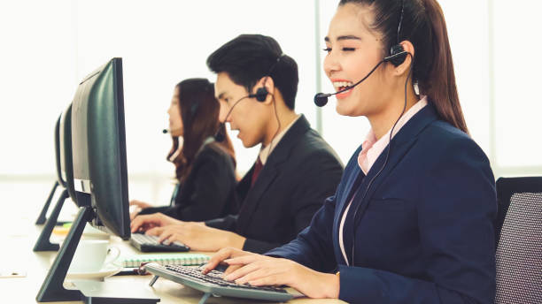 istock Business people wearing headset working in office 1286662011