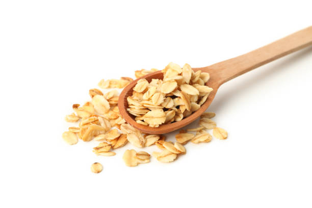 istock Wooden spoon with granola isolated on white background 1286662498