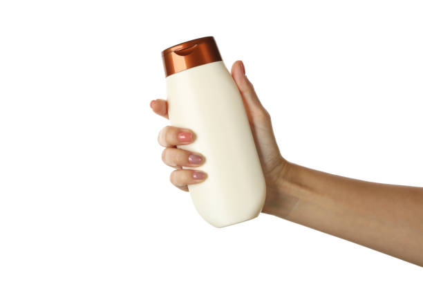 istock Female hand hold bottle with shampoo, isolated on white background 1286663549