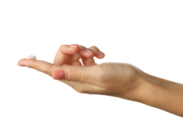 istock Cute female hand with cosmetic cream isolated on white background 1286663606