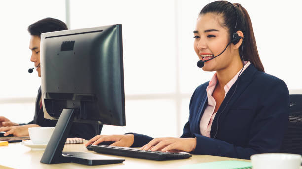 istock Business people wearing headset working in office 1286663774