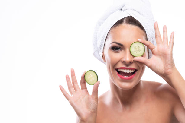 istock Attractive woman using cucumbers as a beauty remedy 1286663944