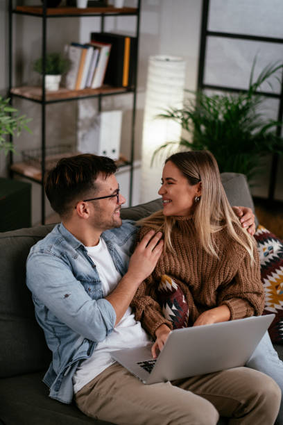 istock Happy young couple with laptop at home 1286664929