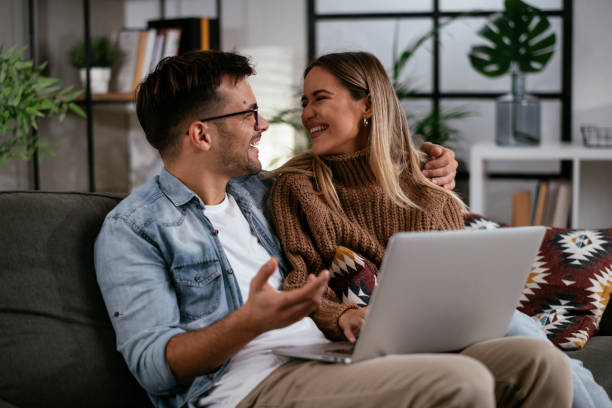 istock Happy young couple with laptop at home 1286665319