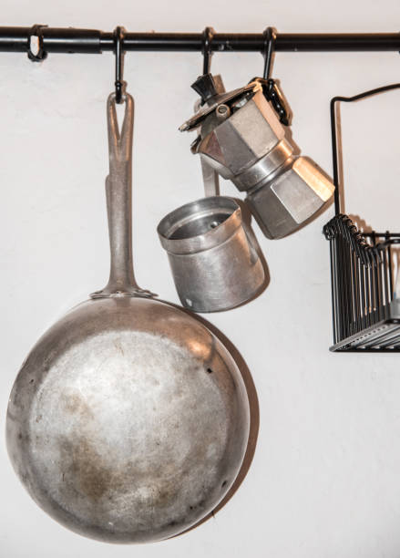 istock kitchen utensils coffee machine, pan hanging on the wall 1286666291