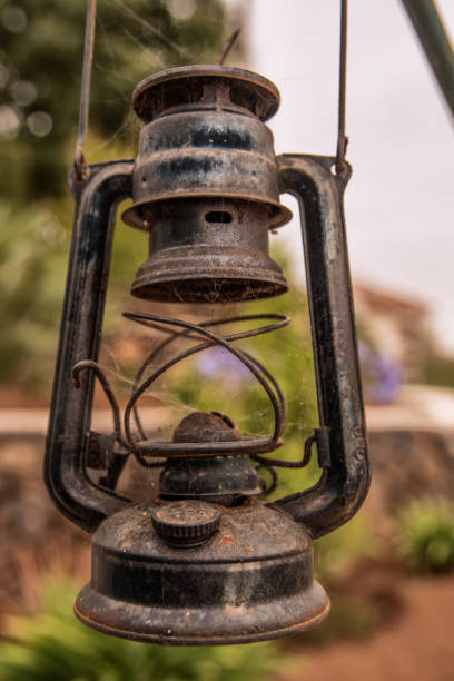 istock Old green gasoline lantern hanging with blurred background 1286666362