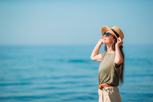 istock Young beautiful woman having fun on tropical seashore. 1286666541