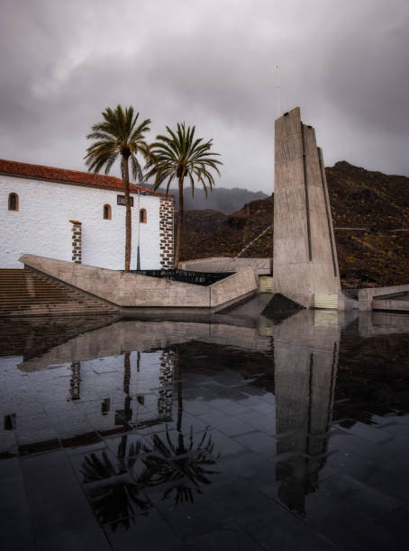 construction that is reflected on the wet ground of a public square in Adeje Tenerife South stock photo
