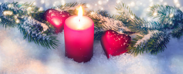 istock classical christmas decoration concept with snow, xmas tree branch and shiny red candlelight 1286667038