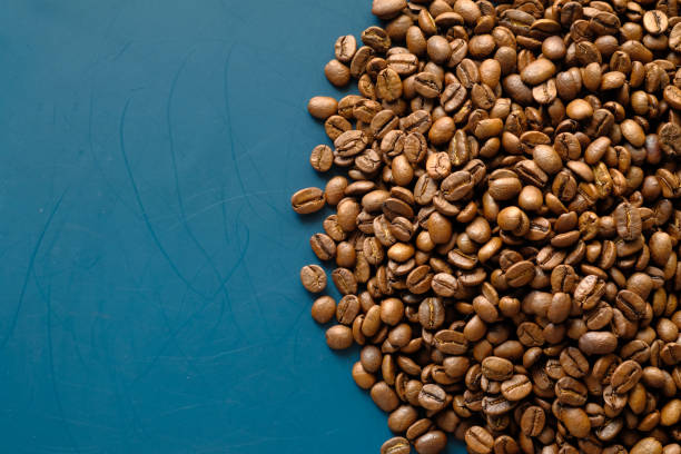 istock top view of fresh coffee beans on color background with copy space. 1286667332