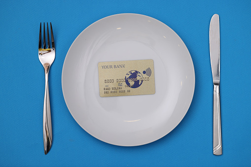 Plastic credit card is on white plate. Banking offers for business concept