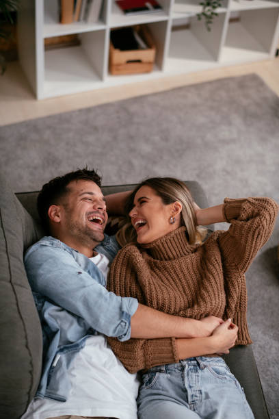 istock Young loving couple relaxing on sofa together. 1286668397