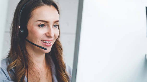 istock Business people wearing headset working in office 1286670785