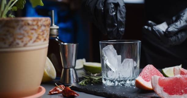 istock Human hands are making a mocktail with various citrus juices and rosemary 1286671375