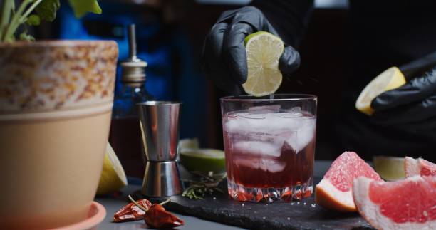 istock Human hands are making a mocktail with various citrus juices and rosemary 1286671409